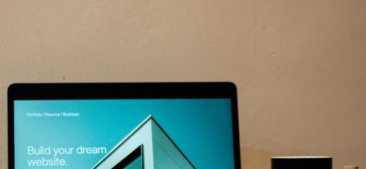 a laptop computer sitting on top of a wooden desk