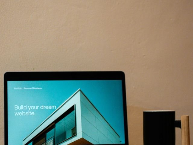 a laptop computer sitting on top of a wooden desk