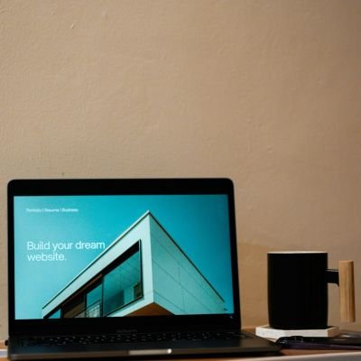 a laptop computer sitting on top of a wooden desk